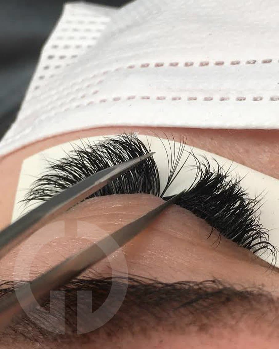 Detailed shot of professionally applied volume lash extensions on a client